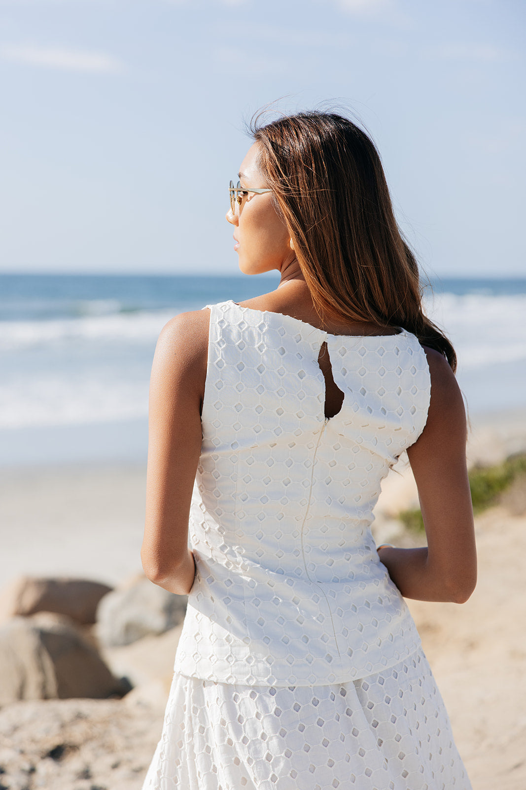 High end chic tailored fit eyelet top with boatneck, keyhole back, and hidden zipper