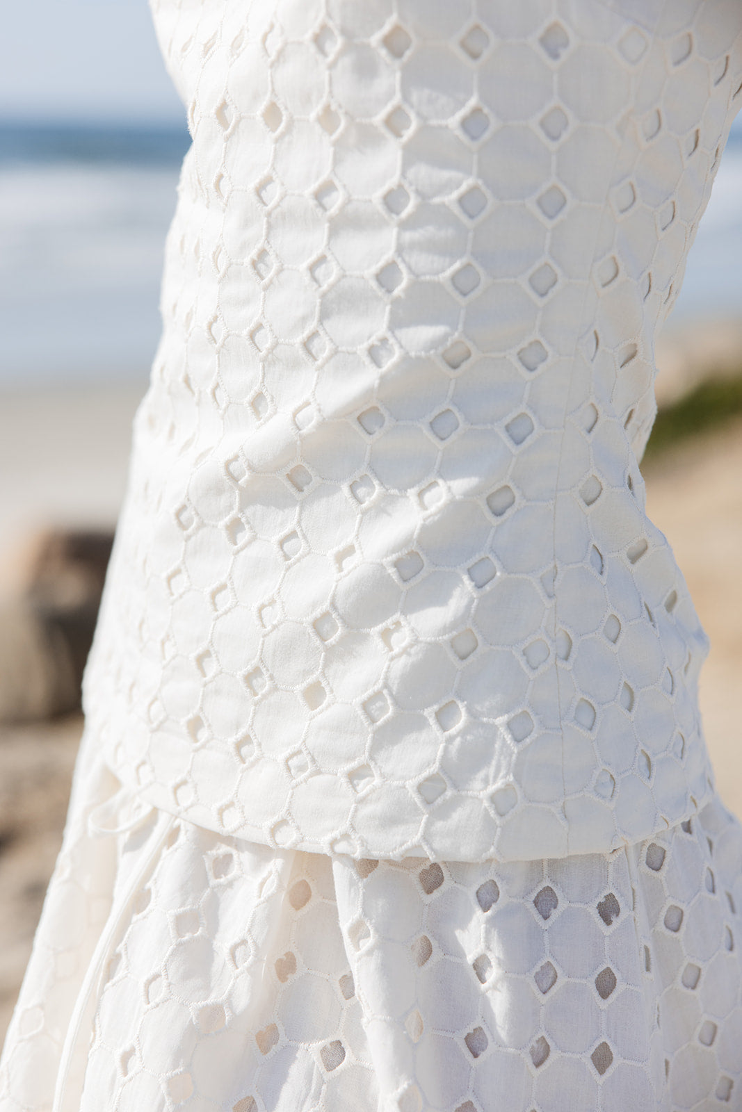 High end chic tailored fit eyelet top with boatneck that's inspired by iconic 90s styles