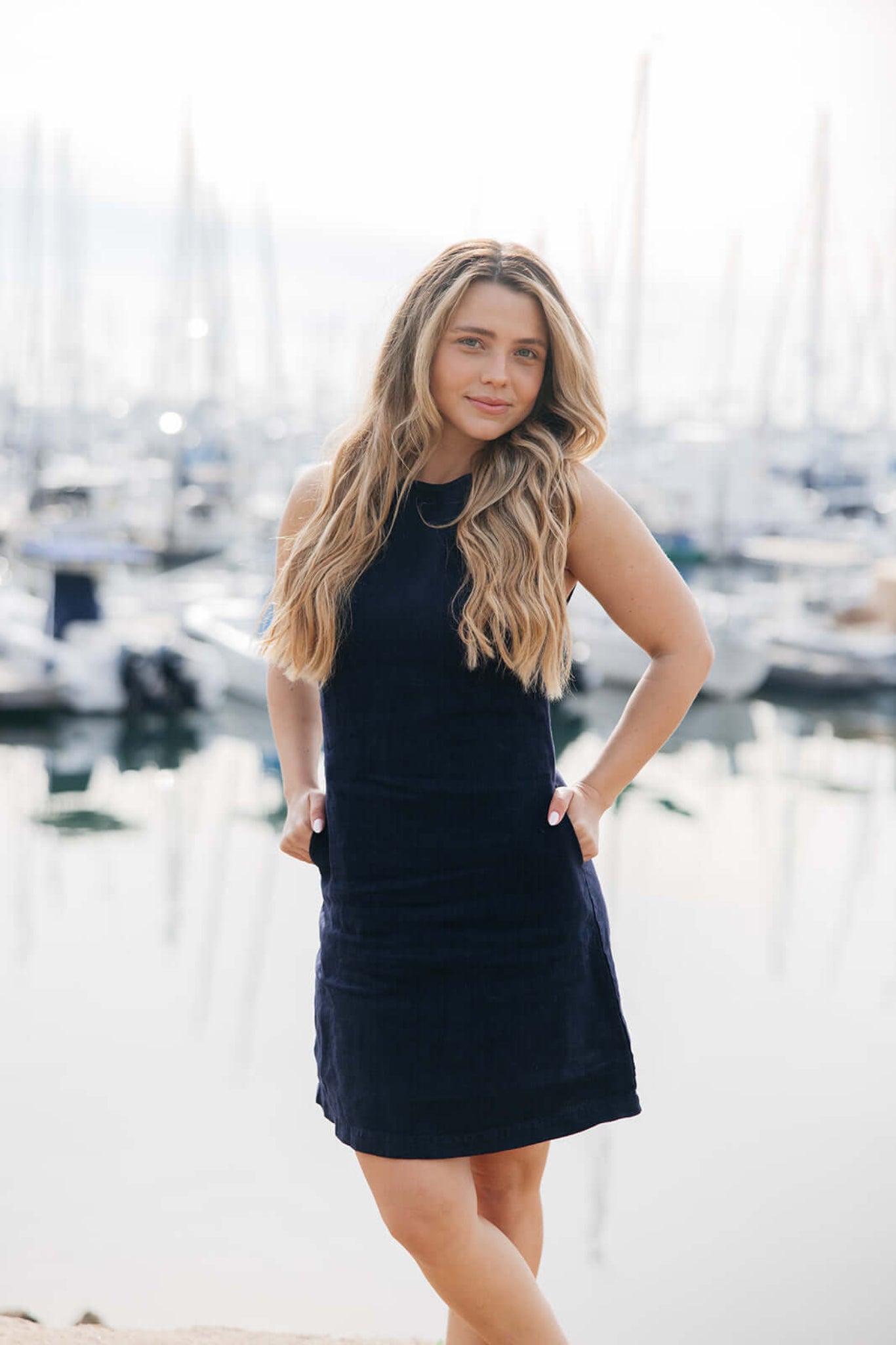 Model wearing Jackie Linen Shift Dress in navy | linen | styled with gold jewelry and sandals | in a marina